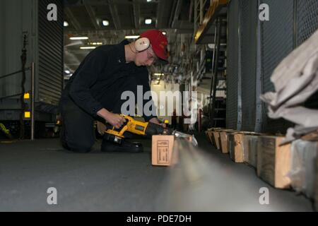 PACIFIC OCEAN (May 15, 2018) Hull Maintenance Technician 3rd Class Dean Burns, from Louisville, Kentucky, cuts a metal pipe to be placed in storage aboard the aircraft carrier USS John C. Stennis (CVN 74). John C. Stennis is underway conducting routine training as it continues preparing for its next scheduled deployment. Stock Photo