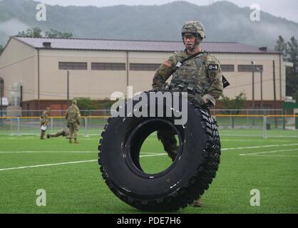U.S. Army 2nd Lt. Brian Trabun, native to Seattle, WA, assigned to the 35th Air Defense Artillery Brigade, performs tire flips at the Physical Fitness Challenge during the Eighth Army 2018 Best Warrior Competition, held at Camp Casey, Republic of Korea, May 17, 2018.  The Eighth Army Best warrior Competition is being held to recognize and select the most qualified junior enlisted and non-commissioned officer to represent Eighth Army at the U.S. Army Pacific Best Warrior Competition at Schofield Barracks, HI. The competition will also recognize the top performing officer, warrant officer and Ko Stock Photo
