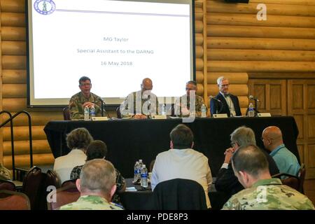 Senior military leaders speak on a panel about the National Guard's role in the U.S. military’s cyber mission force May 16, 2018, as part of Cyber Shield 18, in Camp Atterbury, Ind., an exercise bringing together more than 800 soldiers, airmen, and civilians from 40 states and territories to test their skills in response to cyber-incidents. The panel included (from left to right) Maj. Gen. Stephen G. Fogarty, the commander of U.S. Army Cyber Command, Maj. Gen. James E. Taylor, the special assistant to the Director of the Army National Guard for Operations, Plans, and Strategy, Brig. Gen. Neil  Stock Photo