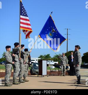 A 9th Security Forces Squadron color guard presents the Air Force and American flags during a National Police Week memorial ceremony May 18, 2018, at Beale Air Force Base, California. In 1962, President John Kennedy proclaimed May 15 as National Peace Officers Memorial Day and the week it falls on as National Police Week. Stock Photo