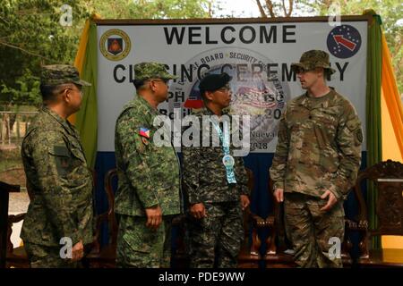 From left to right: Philippine Army Lt. Col. Arnel Cabugon, commander of the 48th Infantry Battalion, Col. Laurence Mina, commander of the Joint Task Force Salaknib, Brig. Gen. Corleto Vinluan, commander of the Light Reaction Regiment, and U.S. Army Lt. Col James Hart, commander of 1st Battalion, 21st Infantry Regiment, 2nd Infantry Brigade Combat Team, 25th Infantry Division, discuss the benefits of partnering together at the end of the Balikatan Closing Ceremony on Fort Magsaysay, Philippines May 17, 2018. Exercise Balikatan, in its 34th iteration, is an annual U.S.-Philippine military train Stock Photo