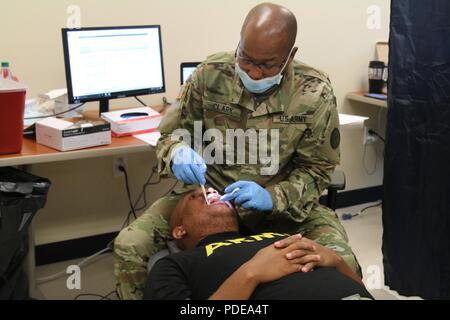 Pfc. DA-Aldo Prince, 661st Military Police Law & Order Detachment, Virgin Islands National Guard, receives a dental examination during the VING’s annual Periodic Health Assessment held on St. Croix, VI, May 19, 2018. The assessment is designed to measure a soldier’s current state of health and their ability to deploy. Stock Photo