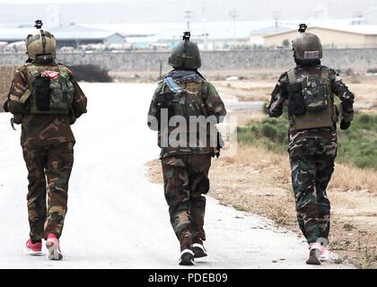 KABUL, Afghanistan (May 13, 2018) -- Female Tactical Platoon members run a 5k in full protective gear during a KPAT, or physical assessment test, near Kabul, Afghanistan, May 13, 2018. The KPAT is conducted twice a year to assess the women’s physical conditioning and includes a 3-mile run and a series of obstacles. The Female Tactical Platoon supports Afghan Special Security Forces during counterterrorism operations, specializing in the search, questioning and medical assistance of women and children. (Resolute Support Stock Photo