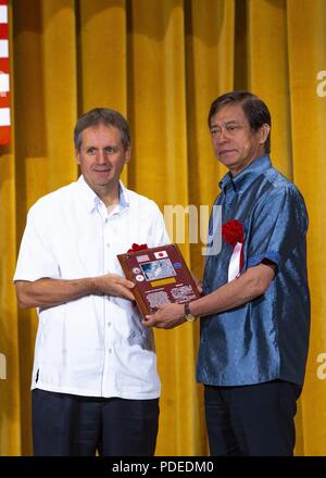 NAHA, OKINAWA, Japan - Joel Ehrendreich, left, receives a certificate of commemoration from Kiichiro Jahana during a land return ceremony May 20 at the Naha Terrace hotel in Naha, Okinawa, Japan. Since 1972, the Marine Corps has returned more than 7,200 hectares of land and approximately 8,000 hectares of water area back to the people of Okinawa. Ehrendreich is the U.S. Consul General at the U.S. Consulate in Naha, Japan. Jahana is the vice governor of Okinawa Prefecture. Stock Photo