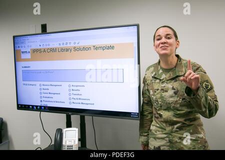 CW2 Sara Smith, Systems Integration Branch (SIB) Chief with the Mississippi Army National Guard Joint Force Headquarters, discusses the Integrated Personnel and Pay System – Army’s (IPPS-A) Customer Relationship Management (CRM) library with her fellow Warrant Officers at Arlington, Va. on May 17. 2-18. HR Professionals like Smith will have access to 21st century customer support software, which automates, tracks and manages Soldier HR and pay inquiries. Stock Photo