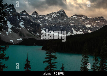 Arriving at Moraine Lake in Banff, Alberta just as the sun began to rise and tickle the clouds above the Valley of the Ten Peaks. Stock Photo