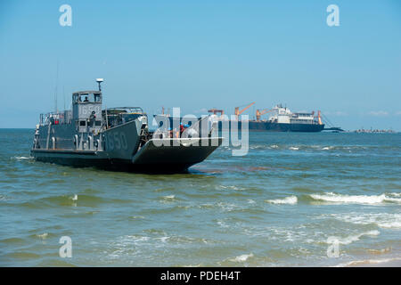 VIRGINIA BEACH, Va. (July 26, 2018) An Assault Craft Unit (ACU) 2 Landing Craft Utility (LCU) 1600 begins lowering the bow ramp in order to offload U.S. Army vehicles after stabbing Utah Beach during the Trident Sun 18 exercise onboard Joint Expeditionary Base Little Creek – Fort Story. Trident Sun 18 is a maritime prepositioning force (MPF) operation intended to provide training to reserve component personnel with regards to the in stream offload of military vehicles and equipment. (U.S. Navy photo by Mass Communication Specialist 2nd Class Kenneth Gardner) Stock Photo