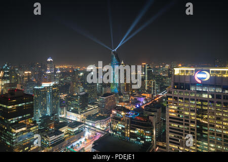 Night view with skyscraper in business district in Bangkok Thailand. Light show at Magnolias Ratchaprasong in Bangkok, Thailand. Stock Photo