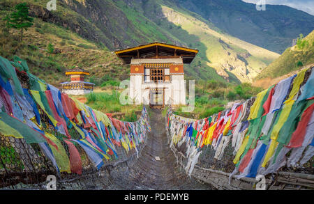 Hanging bridge with colourful Buddhist prayer flags in Paro Bhutan Stock Photo