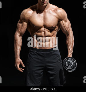 Close up of man showing muscular body and six pack abs. Photo of