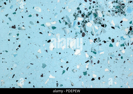 Abstract texture of old artificial marble background with white and black particles. Blue mosaic floor with stone inserts and cracks. Stock Photo