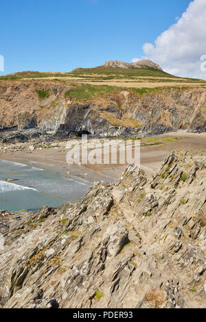 Rugged rocky bay next to Whitesands Beach in Pembrokeshire South Wales on a sunny clear day with white puffy clouds Stock Photo