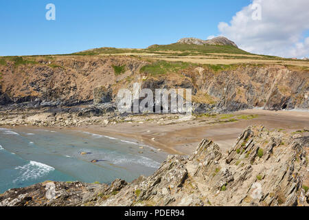 Rugged rocky bay next to Whitesands Beach in Pembrokeshire South Wales on a sunny clear day with white puffy clouds Stock Photo