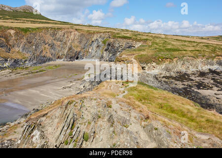 Rugged rocky bay next to Whitesands Beach in Pembrokeshire South Wales on a sunny clear day with white puffy clouds Stock Photo