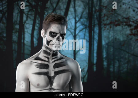 halloween scary skeleton man portrait in studio at dark forest Stock Photo