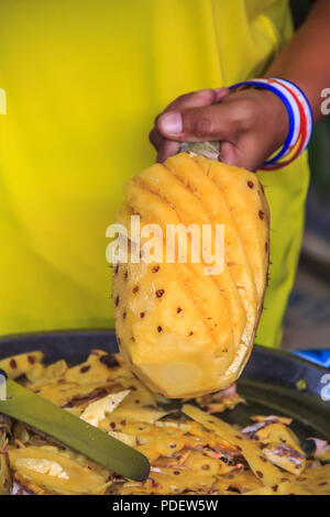 Fresh pineapple being sliced at the Market in Krabi Town, Thailand Stock Photo