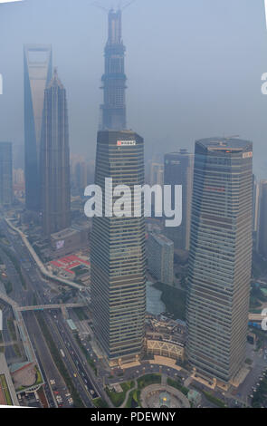 Shanghai, China - June 16, 2013: Heavily polluted skyline with Shanghai World Financial Center. Heavy air pollution has become common in China.