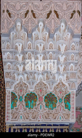 Painted Moroccan plaster arabesque carving on a wall of a riad in Fes, Morocco Stock Photo