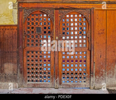 Courtyard of Al Karaouine Koran University Door viewed through the Moroccan Cedar Wood Carved Door of the Al Karaouine Koran University in Fes, Morocc Stock Photo