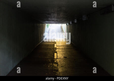 underpass in urban city with light at the end daytime Stock Photo