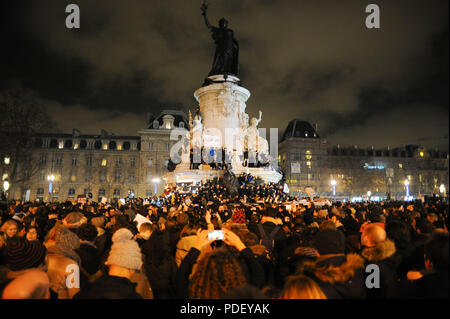 January 07, 2015 - Paris, France:  Tens of thousands of people gather in Place de la Republique in central Paris after a deadly attack on a French satirical magazine. Gunmen attacked the offices of French satirical weekly Charlie Hebdo in Paris on Wednesday, killing at least 12 people in what President Franois Hollande said was 'undoubtedly a terrorist attack'. Des dizaines de milliers de personnes se rassemblent place de la Republique en hommage aux victimes de l'attentat contre Charlie Hebdo, quelques heures apres la fusillade meurtriere. *** FRANCE OUT / NO SALES TO FRENCH MEDIA *** Stock Photo
