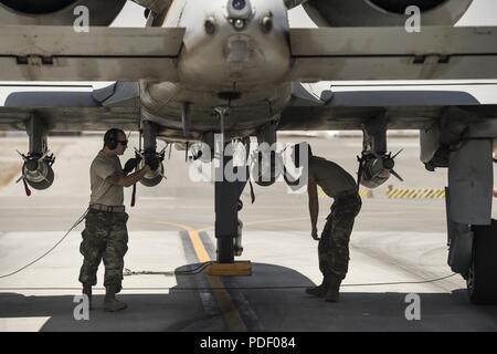 U.S. Air Force 122nd Fighter Wing weapon loaders prepare an A-10 Thunderbolt II for flight at Kandahar Airfield, Afghanistan, May 20, 2018. Attached to the 451st Air Expeditionary Group (AEG), the aircraft are providing close-air support for coalition and Afghan forces on the front lines. The 451st AEG provides an airpower presence in the Afghanistan area of operations. Stock Photo