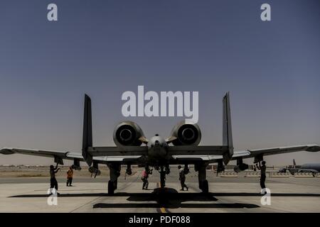 U.S. Air Force 122nd Fighter Wing weapon loaders prepare an A-10 Thunderbolt II for flight at Kandahar Airfield, Afghanistan, May 20, 2018. Attached to the 451st Air Expeditionary Group (AEG), the aircraft are providing close-air support for coalition and Afghan forces on the front lines. The 451st AEG provides an airpower presence in the Afghanistan area of operations. Stock Photo