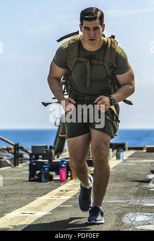 MEDITERRANEAN SEA (May 20, 2018) U.S. Marine Corps Staff Sgt. David M. Benitez, a platoon sergeant assigned to Weapons Platoon, Fox Company, Battalion Landing Team, 2nd Battalion, 6th Marine Regiment, 26th Marine Expeditionary Unit (MEU), competes in a physical training challenge during a U.S. Navy's Morale, Welfare and Recreation event known as Steel Beach aboard the Harpers Ferry-class dock landing USS Oak Hill (LSD 51) in the Mediterranean Sea, May 20, 2018. The Oak Hill, homeported in Virginia Beach, Virginia, and the 26th MEU are conducting naval operations in the 6th Fleet area of operat Stock Photo