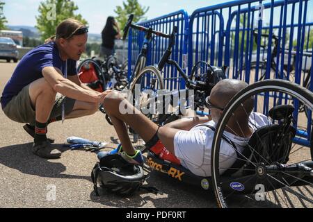 U.S. Army Veteran Spc. Brent Garlic, Armor Crewman, waits while his bike receives maintenance, Colorado Springs, Colorado May 30, 2018. The DoD Warrior Games is an adaptive sports competition for wounded, ill and injured service members and veterans. Approximately 300 athletes representing teams from the Army, Marine Corps, Navy, Air Force, Special Operations Command, United Kingdom Armed Forces, Canadian Armed Forces, and the Australian Defense Force will compete June 1 – June 9 in archery, cycling, track, field, shooting, sitting volleyball, swimming, wheelchair basketball, and - new this ye Stock Photo