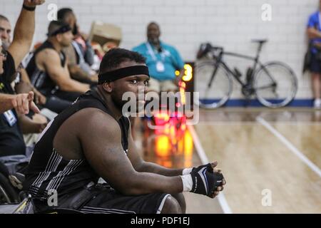U.S. Army Sgt. Cory Ivins, Team Army athlete, watches his team compete in wheelchair basketball, Colorado Springs, Colorado June 03, 2018. The DoD Warrior Games is an adaptive sports competition for wounded, ill and injured service members and veterans. Approximately 300 athletes representing teams from the Army, Marine Corps, Navy, Air Force, Special Operations Command, United Kingdom Armed Forces, Canadian Armed Forces, and the Australian Defense Force will compete June 1 – June 9 in archery, cycling, track, field, shooting, sitting volleyball, swimming, wheelchair basketball, and - new this Stock Photo