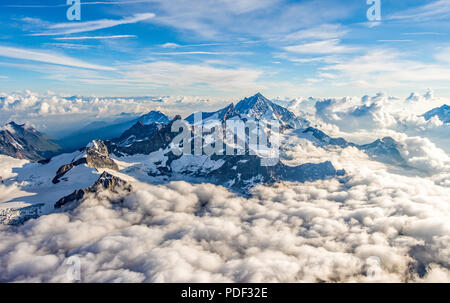 A stunning and dramatic view of the Weisshorn above the clouds as seen from the Matterhorn Stock Photo
