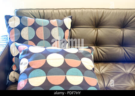 Pillows on leather sofa. Part of brown leather sofa with pillow Stock Photo
