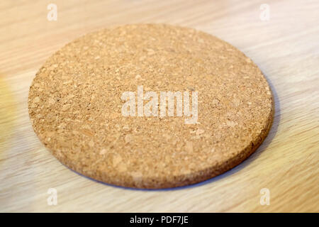 The bamboo surface of the table. Bamboo Cutting Board Texture Wooden Background. Round Cup holders made of cork. For glasses of hot drinks. Stock Photo