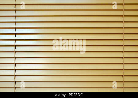 Wooden blinds with daylight illuminating through. Horizontal from the sun. Stock Photo