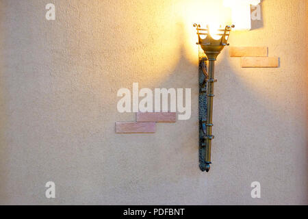 The lamp in the apartment, made like a torch in the middle of the castle. Antique design Stock Photo
