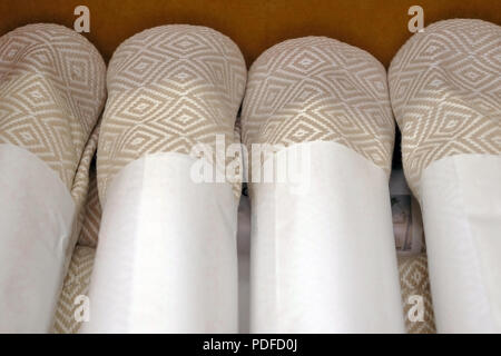 Folded grey cotton napkin isolated on wood table top view background Stock Photo
