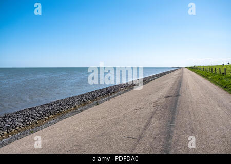 A long strengthened and high dyke along the east coast of the island of Texel, the Netherlands. Stock Photo