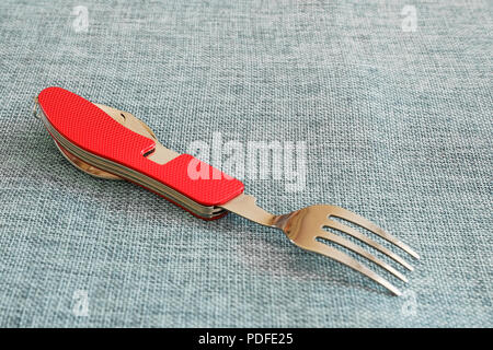 knife, fork, spoon and corkscrew tourist set with red grip Stock Photo