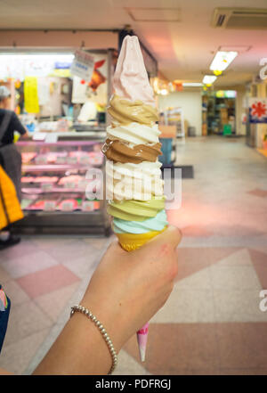 An eight scoop, eight-layer soft serve ice cream cone from Daily Chiko ice cream parlour in Nakano, Tokyo, Japan. Stock Photo