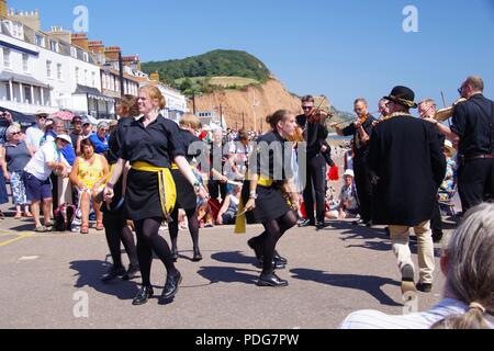 Whip the Cat Rapper and Clog, Women's English Dance Team, Performing a Rapper Sword Dance at Sidmouth Folk Festival, East Devon, UK. August, 2018. Stock Photo