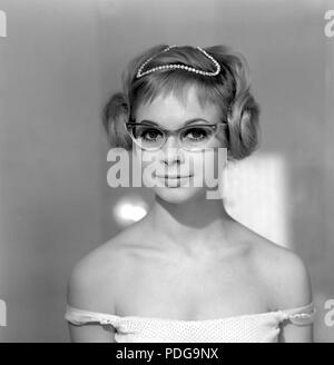 1960s glasses. A young woman in glasses and bows January 1961. Models name Monica Flodqvist Stock Photo