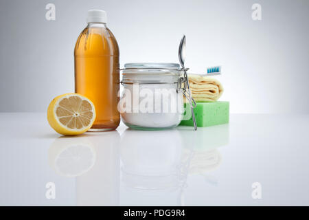 Eco-friendly natural cleaners. Vinegar, baking soda, and lemon on white background. Homemade green cleaning with Copy space Stock Photo