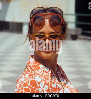 1960s glasses. Summer of 69. The young female fashion model is wearing this years models of sunglasses and accessories. 1969 ref CV25-12 Stock Photo