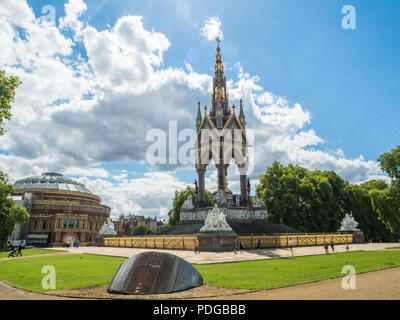 The Gothic Revival Styled Albert Memorial in Kensington Gardens with the Royal Albert (Concert) Hall left, South Kensington, London, England. Stock Photo