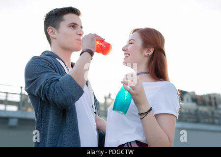 Joyful nice man enjoying his drink So delicious. Stock Photo