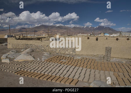 Drying mud bricks for adobe homes in the village of Karakul, Tajikistan Stock Photo