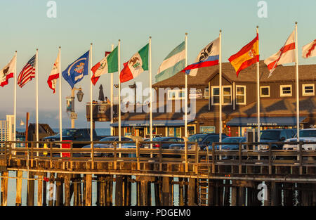 World flags fly at Stearns Wharf in Santa Barbara, California, United States. Stock Photo
