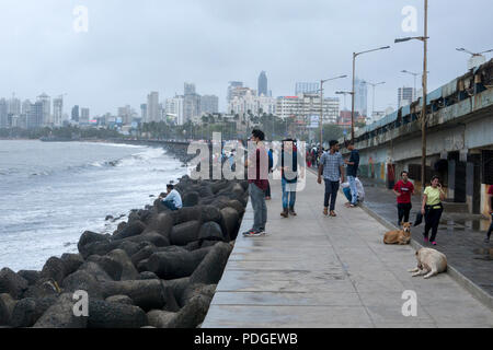 People on Marine Drive promenade during monsoon season in Mumbai, India Stock Photo