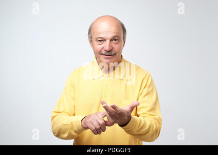 An elderly person finds his money on his fingers. Income from a pension or bank deposit. Stock Photo