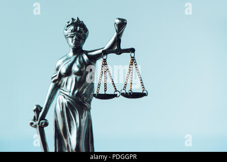 Lady Justice statue in law office. Figurine with blindfold, balance and sword is personification of moral force in judicial system and it's origin is  Stock Photo